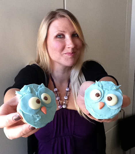 Tamlyn holds up 2 cupcakes - branded with our TLD owls Tamlyn holds up 2 cupcakes - branded with our TLD owls